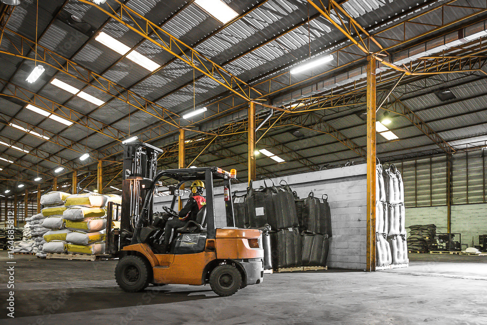 Forklift driver standing proud in manufacturing plant