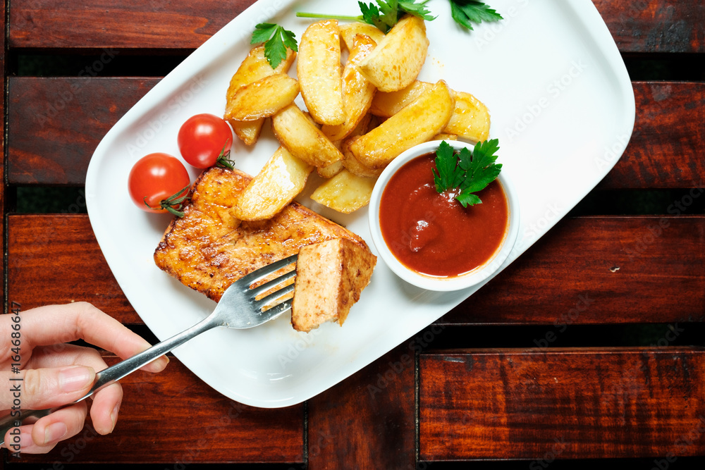 A plate of french fries with catchup, Wooden background