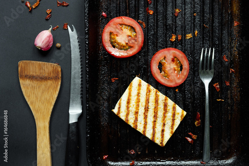 ofu on the grill on the table on a black background, view from the top. photo