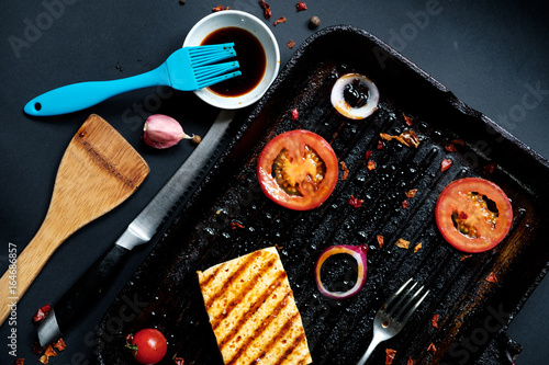 ofu on the grill on the table on a black background, view from the top. photo