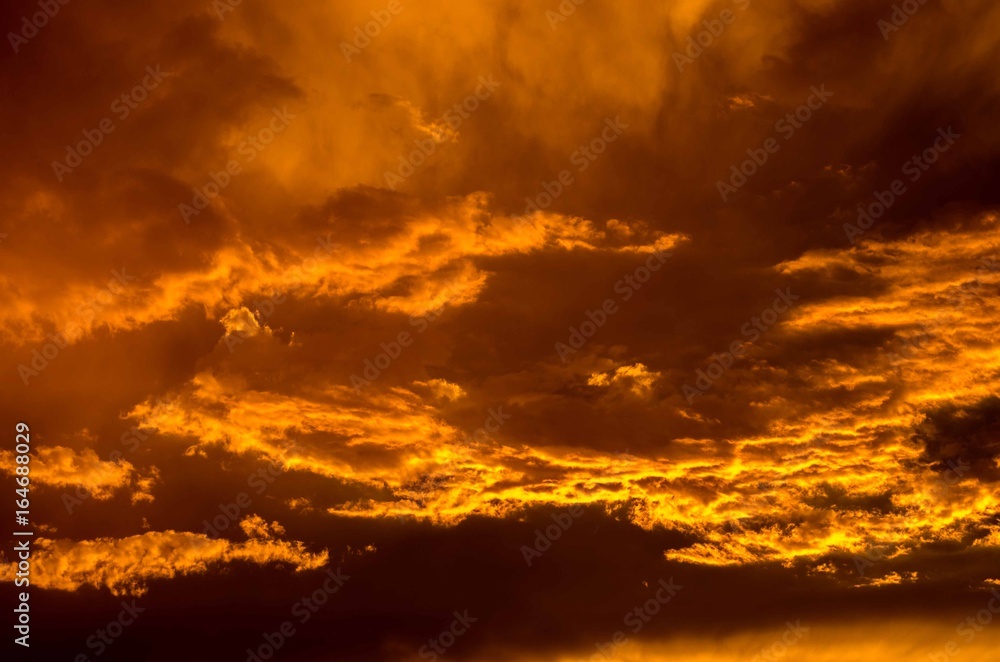 Beautiful and intense sunset with cloudy orange sky
