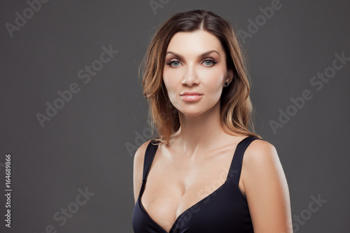 Beautiful sexy brunette woman. Portrait on gray background