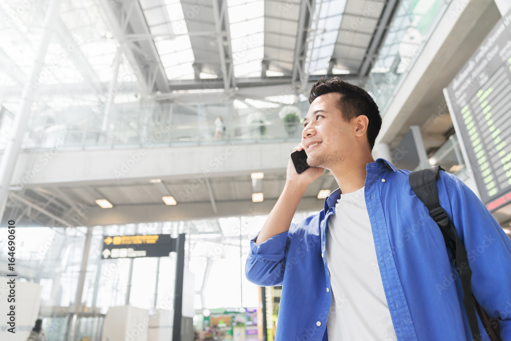 Asian casual smart man lifestyle using mobile phone connection concept. At airport. Asian casual smart man lifestyle using mobile phone connection concept. At airport.