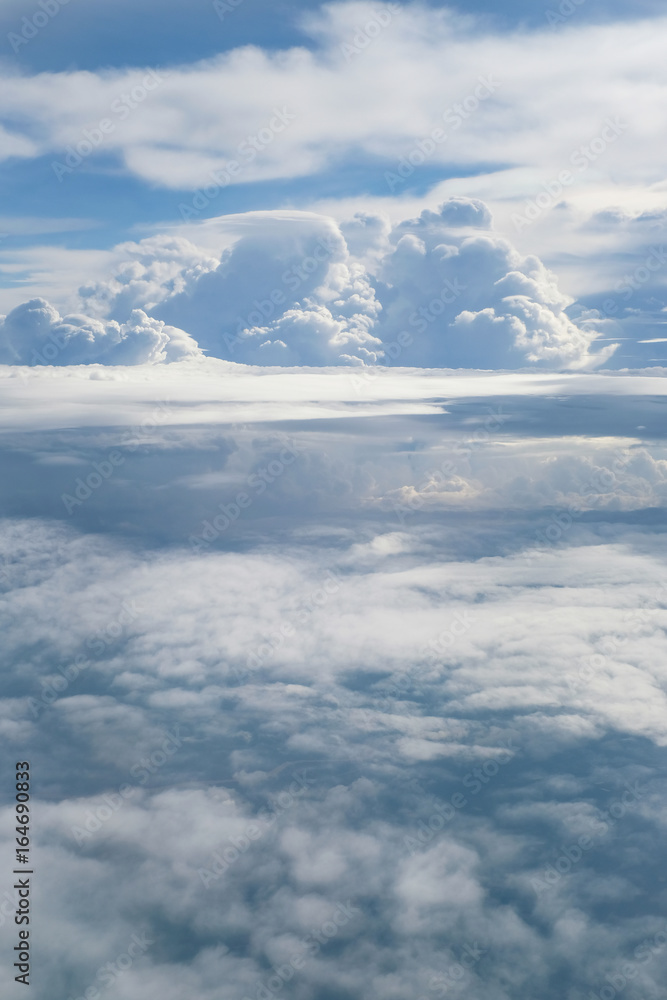Aerial view from the plane of fluffy rain cloud in daytime - Cloudscape