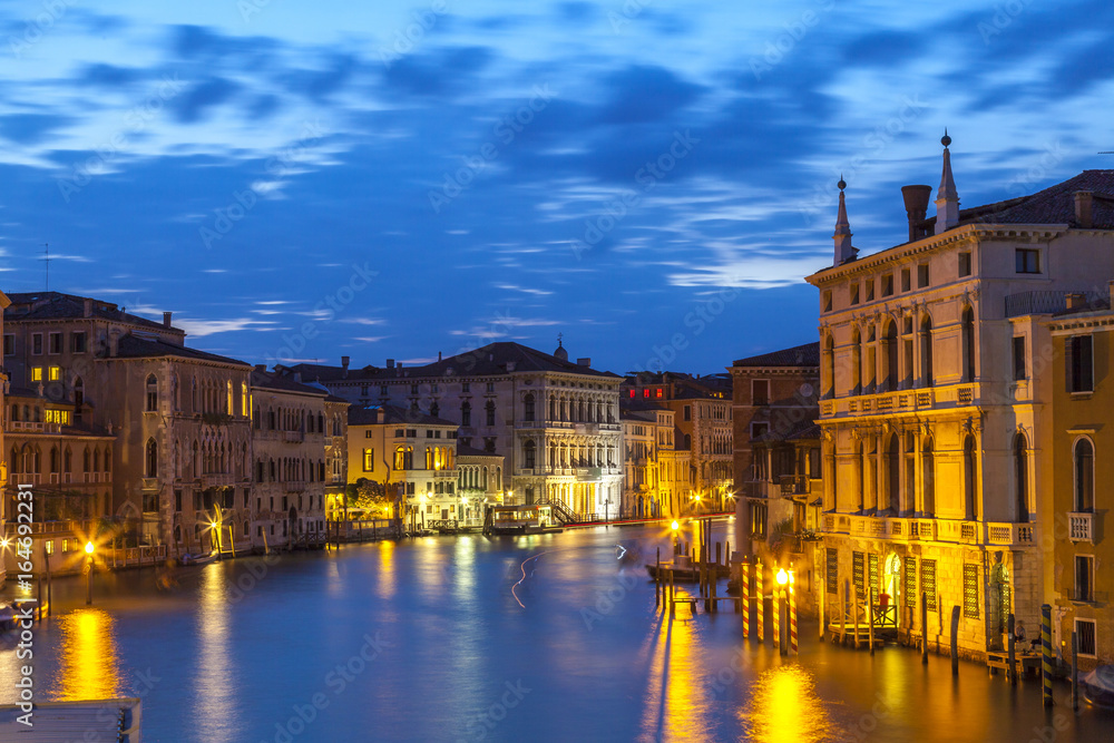Palazzos on the Grand Canal, Venice, Veneto,  Italy at night during blue hour with lights reflected on the water of the canal
