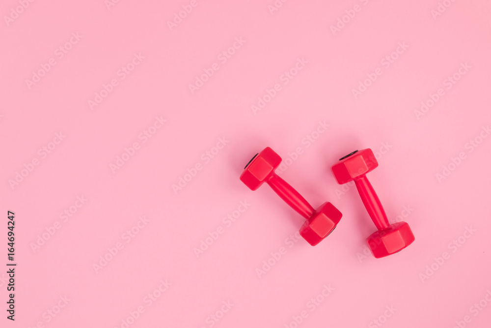 top view of red dumbbells for fitness isolated on pink background top view of red dumbbells for fitness isolated on pink background