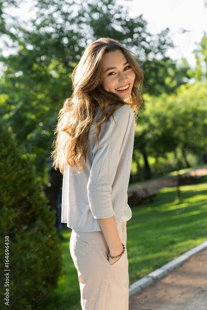 Happy young woman outdoors in park posing Happy young woman outdoors in park posing