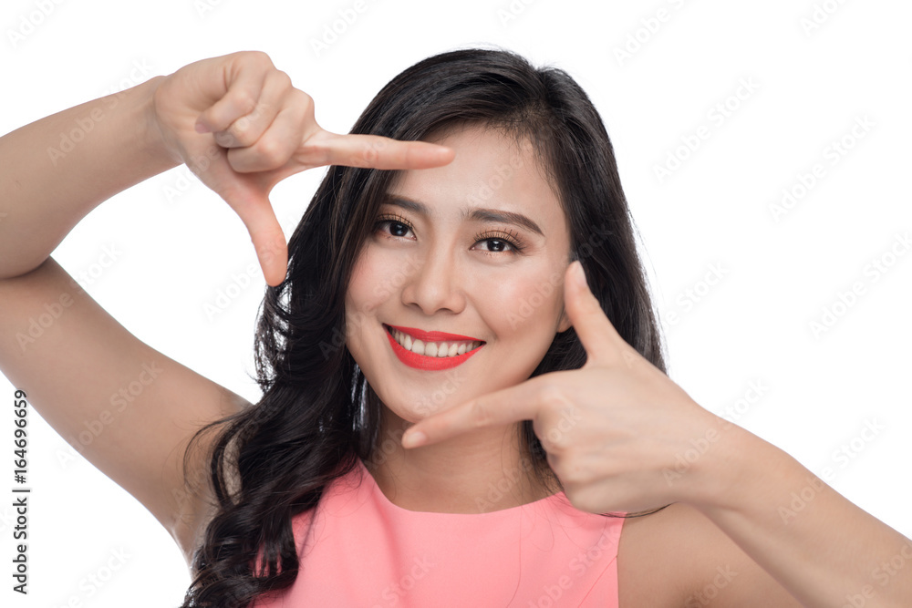 Beautiful woman making a frame with fingers in front of face Beautiful woman making a frame with fingers in front of face