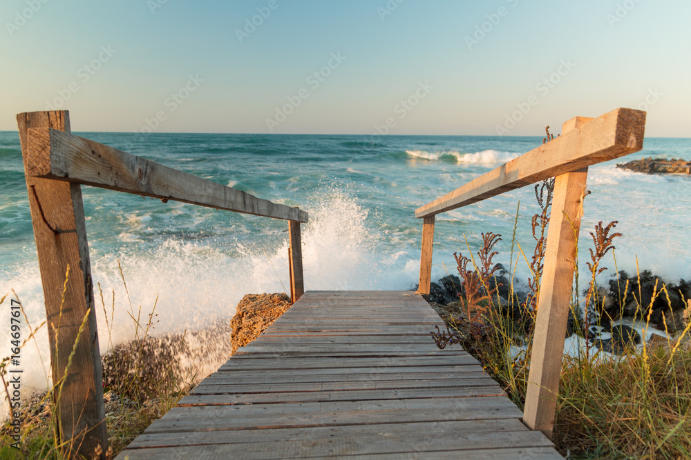 WOODEN BRIDGE NEAR THE BEACH ON SUNSET WOODEN BRIDGE NEAR THE BEACH ON SUNSET