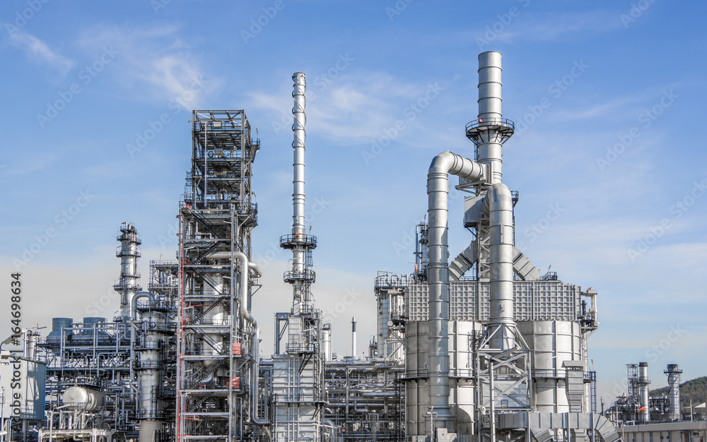 Fototapeta premium Industrial zone,The equipment of oil refining,Close-up of industrial pipelines of an oil-refinery plant,Detail of oil pipeline with valves in large oil refinery.
