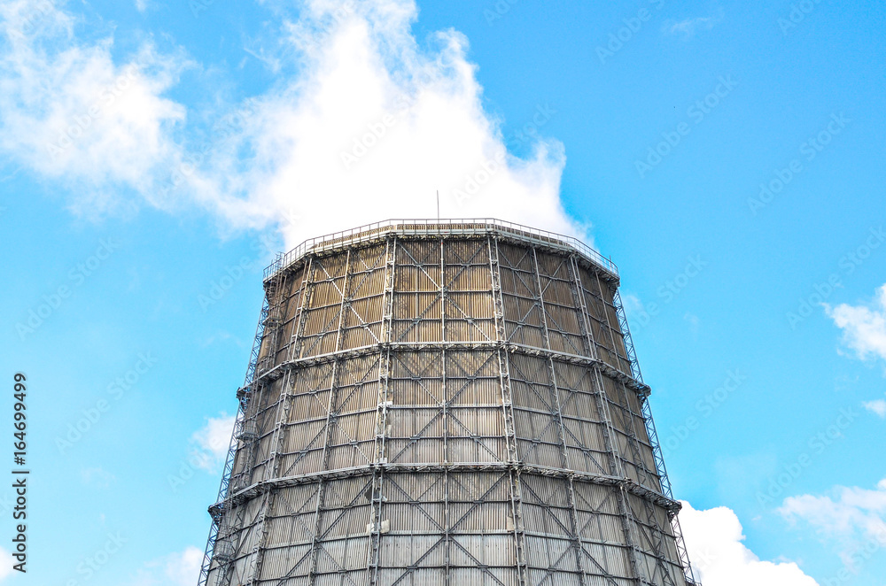 Industrial view cooling tower at metallurgical plant with cloudy sky