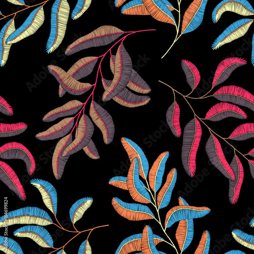 Embroidered branches on a black background. Seamless print. Handmade.