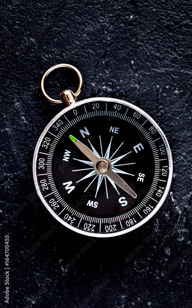 compass on dark background concept - direction motion top view compass on dark background concept - direction motion top view