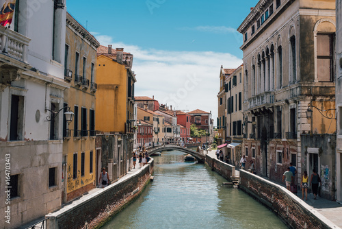 View on a venetian canal with ancient buildings and bridge in Venice © Olga Mai
