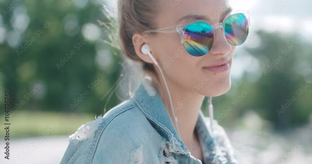 Young woman with headphones enjoying time in a city. Young woman with headphones enjoying time in a city.