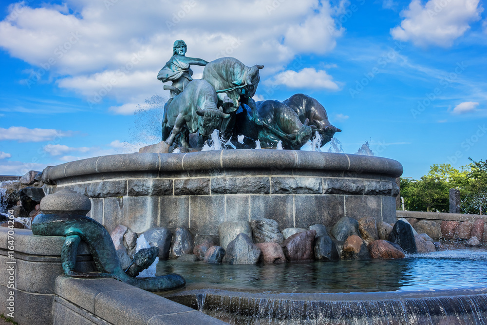 View of famous Gefion Fountain (Gefionspringvandet 1899) in Copenhagen. Gefion Fountain depicting legendary Norse goddess driving four oxen. It was designed by Danish artist Anders Bundgaard. Denmark. View of famous Gefion Fountain (Gefionspringvandet 1899) in Copenhagen. Gefion Fountain depicting legendary Norse goddess driving four oxen. It was designed by Danish artist Anders Bundgaard. Denmark.