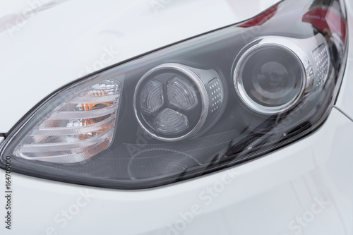 Headlight with lens of a modern car © krigo