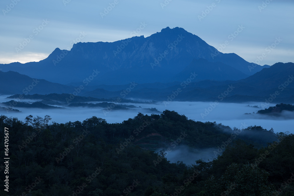 Mount Kinabalu with Cloudy Sky at Tamparuli, Sabah, Borneo Mount Kinabalu with Cloudy Sky at Tamparuli, Sabah, Borneo