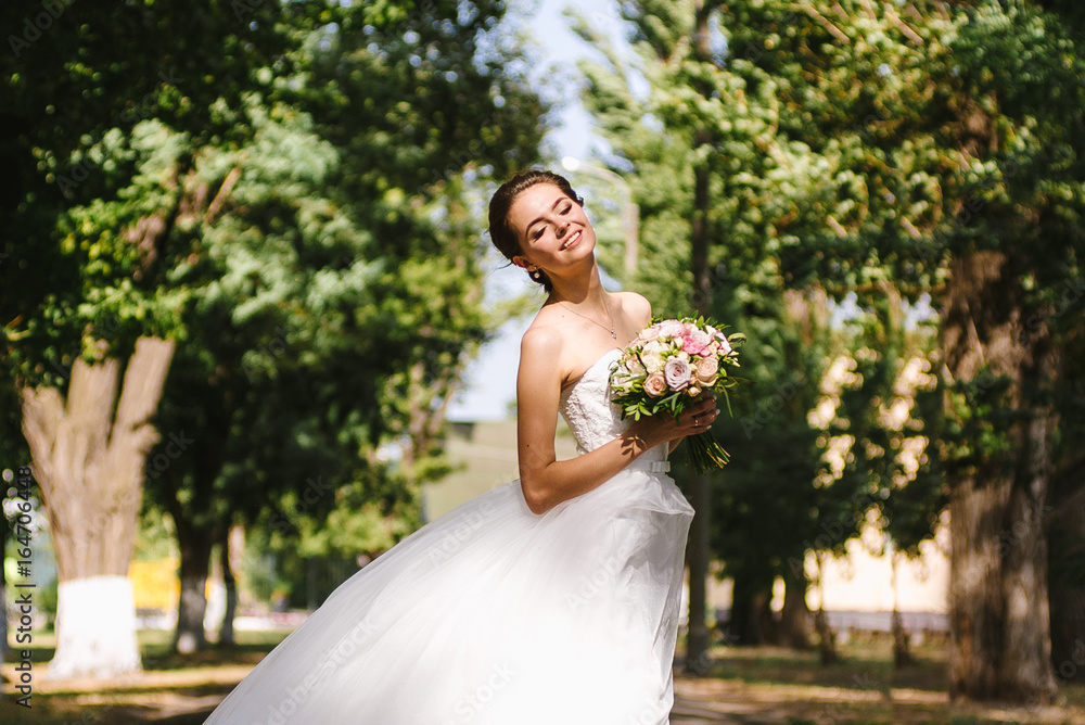 Beautiful brunette bride portrait in summer park Beautiful brunette bride portrait in summer park