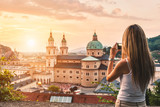 Tourist taking a photo of beatiful sunset in Salzburg Austria