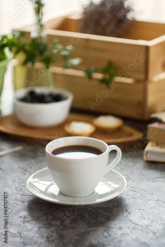 Cup of coffee and sweet cakes with berries. Morning breakfast concept