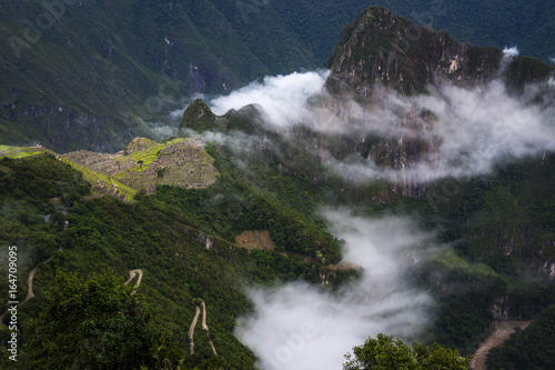 View of Machu Picchu surrounded by clouds from the Sun Gate and the Urubamba River  in Peru  South America