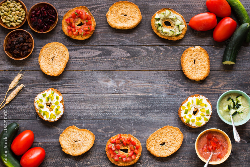 Italian bruschetta with cheese, tomato sauce, cucumber sauce, and herbs, on a wooden background. Italian bruschetta with cheese, tomato sauce, cucumber sauce, and herbs, on a wooden background.