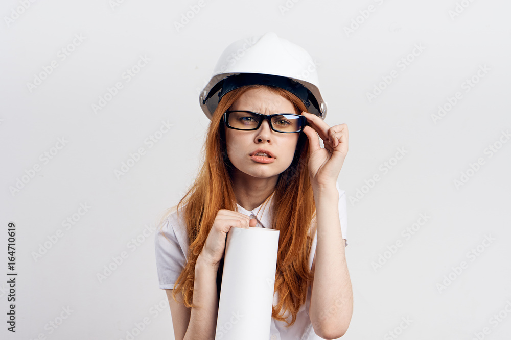 Young beautiful woman on white isolated background holds blueprints, engineer, designer Young beautiful woman on white isolated background holds blueprints, engineer, designer