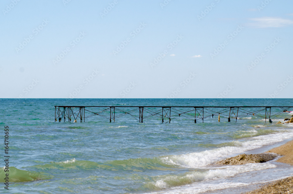 Old ruined pier on the beach