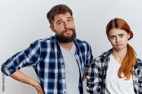 Young beautiful woman with a guy with a beard on white isolated background, repair, construction tools