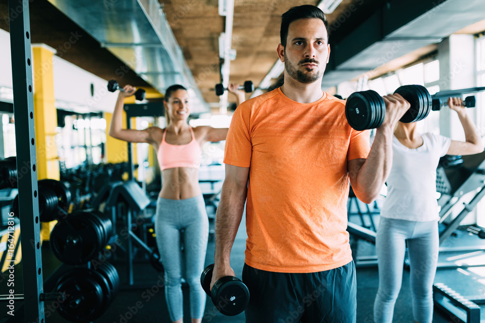 Young attractive man doing exercises in gym Young attractive man doing exercises in gym