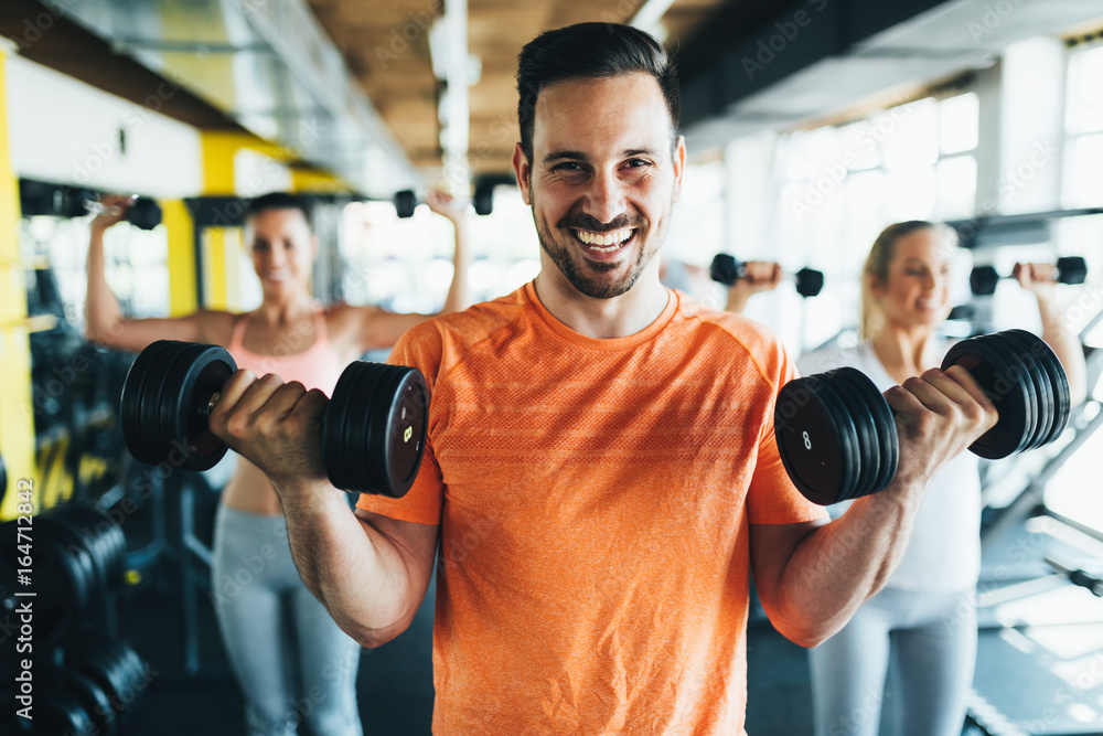 Group of friends exercising together in gym Group of friends exercising together in gym