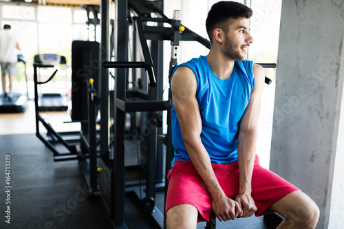 Young man at gym having break from workout
