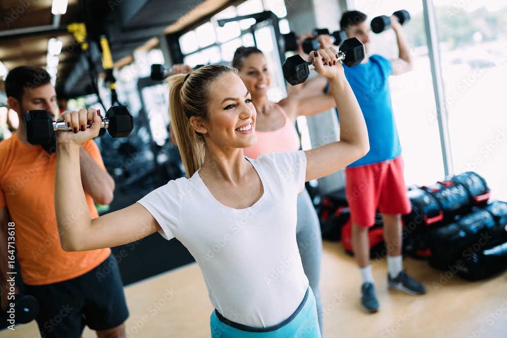 Fototapeta premium Group of people training together in gym