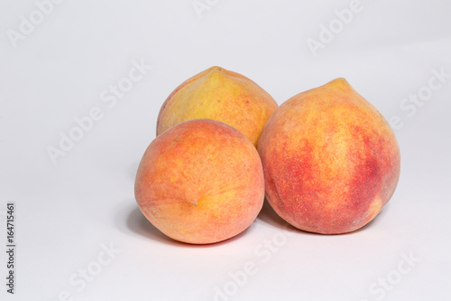3 ripe peaches isolated on white