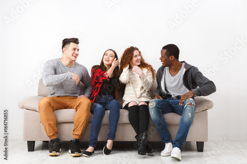 Leisure and party time, friends sitting on couch