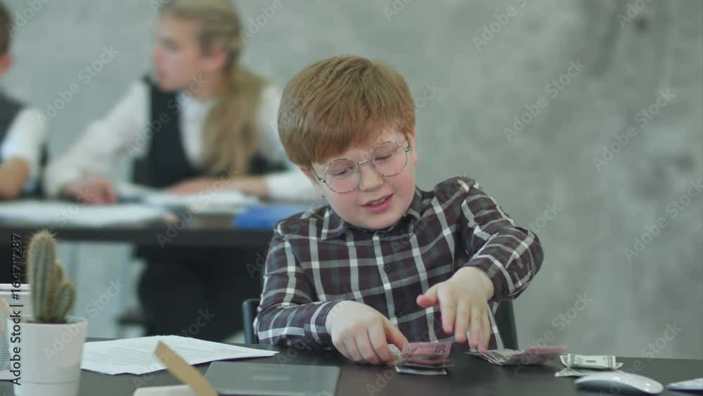 Business boy in eyeglasses counting money, dollars Business boy in eyeglasses counting money, dollars