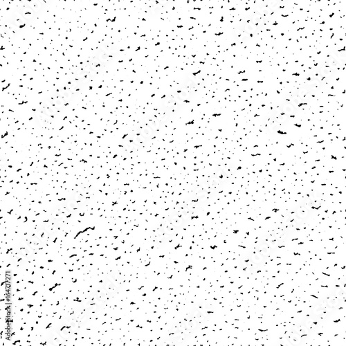 Seamless pattern, dense grunge textured hand drawn black spots. Vector illustration