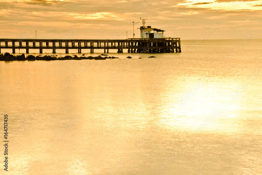 silhouette fishing pier,have sea space on foreground,use for background.