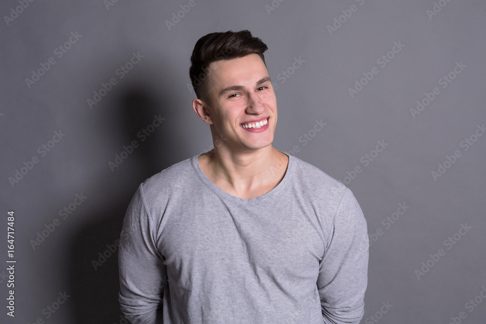 Satisfied young man with happy facial expression Satisfied young man with happy facial expression