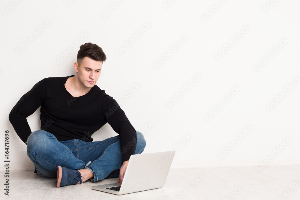 Young man freelancer in casual with laptop Young man freelancer in casual with laptop