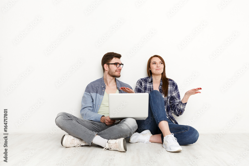 Couple discuss design project for home interior Couple discuss design project for home interior