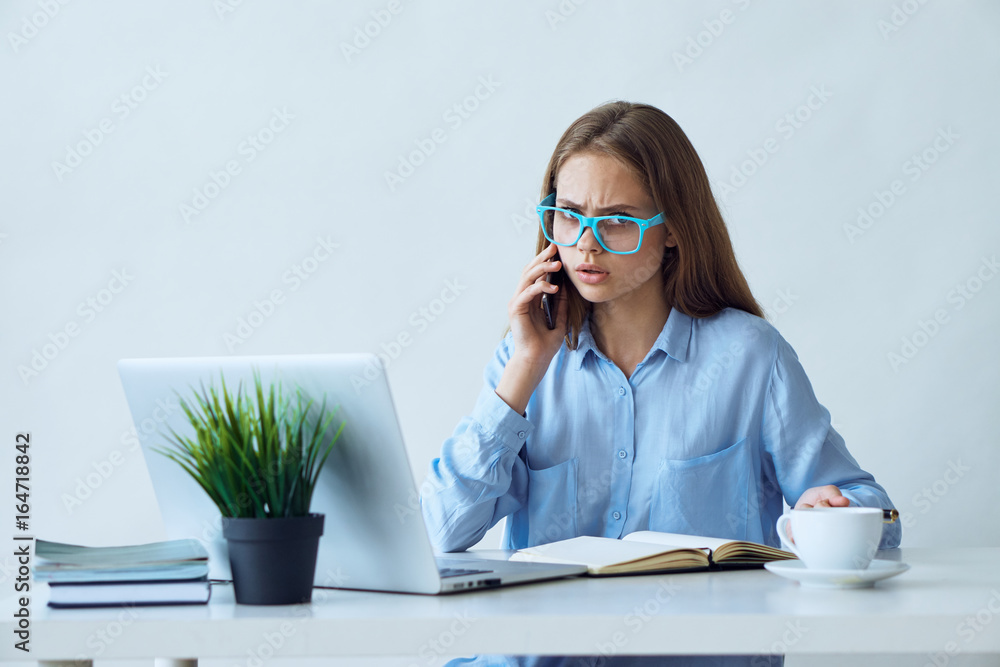 Young beautiful woman working at computer in office