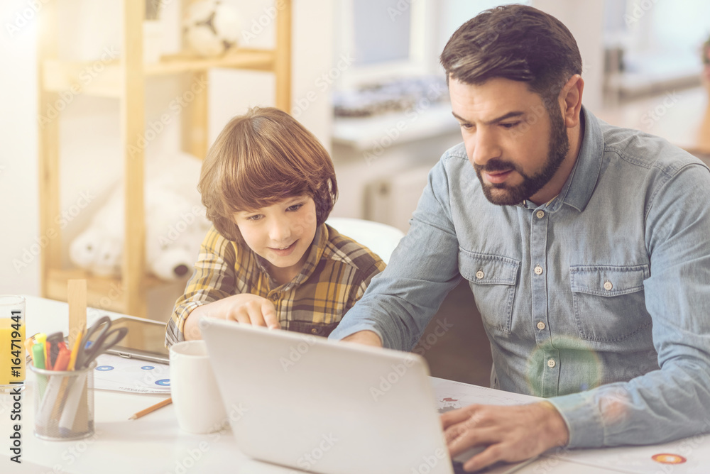 Handsome nice father using a laptop Handsome nice father using a laptop