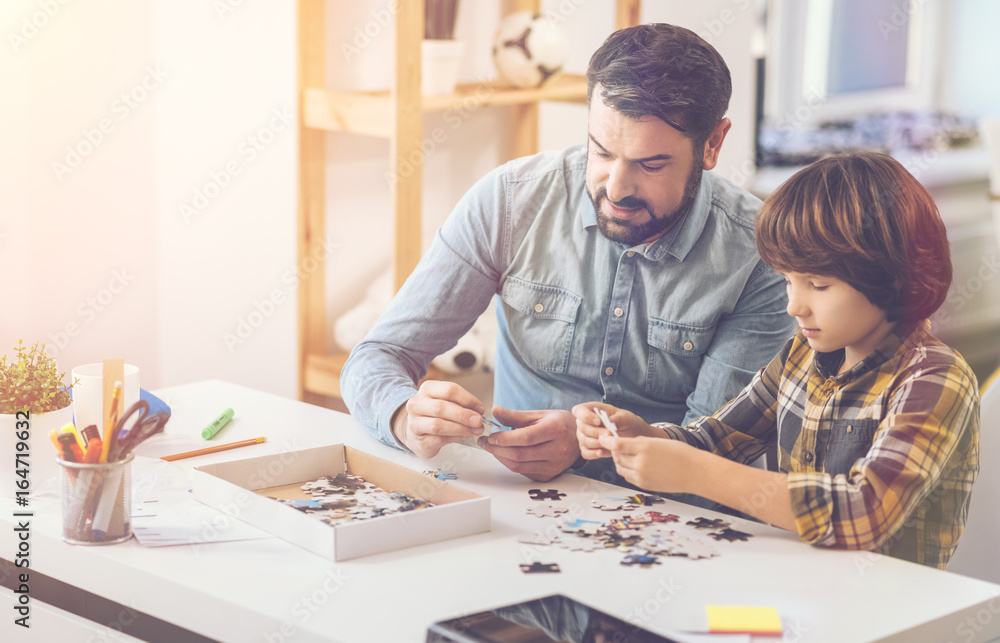 Pleasant positive father and son spending time together Pleasant positive father and son spending time together