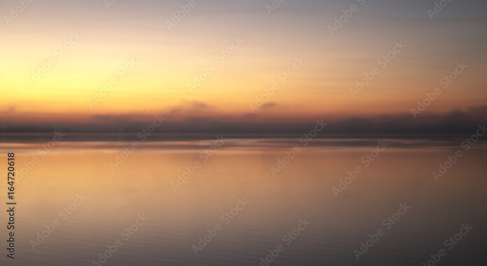 Sunrise with fog over lake