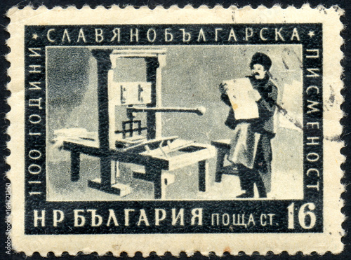 UKRAINE - CIRCA 2017: A postage stamp printed in Bulgaria shows First Printing Deduction in Cyrillic, from series 1100 Years Cyrillic Alphabet, circa 1955 photo