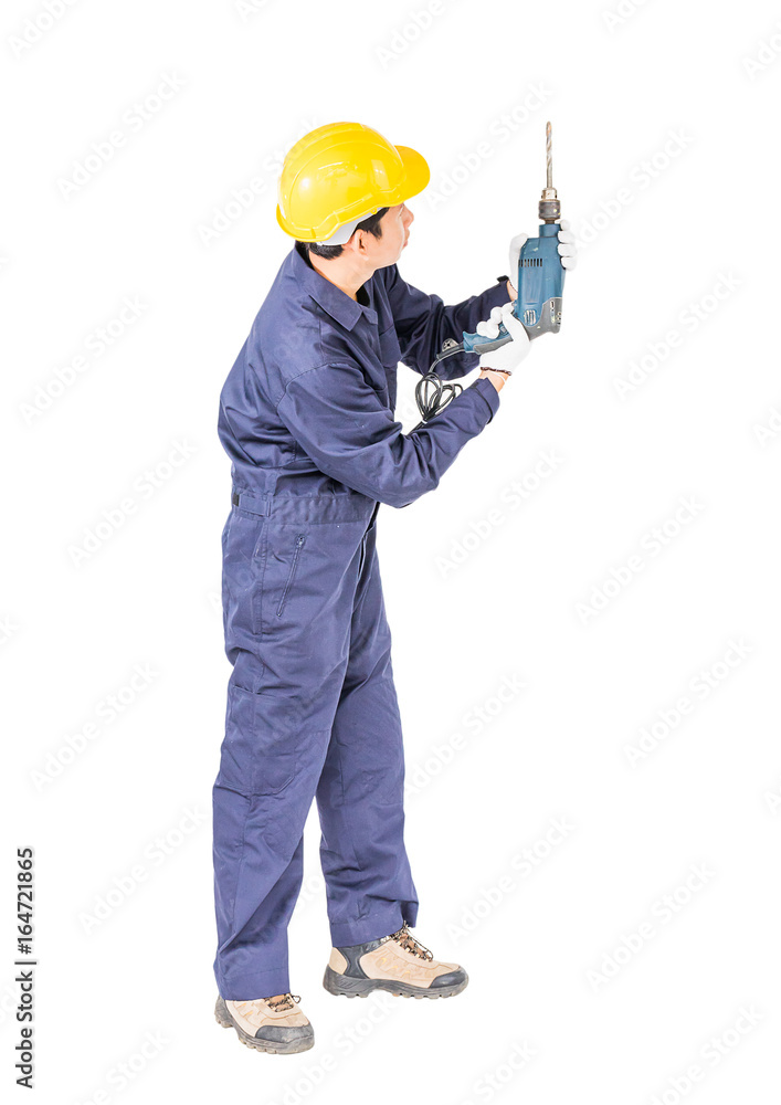 Handyman in unifrom standing with his electric drill Handyman in unifrom standing with his electric drill
