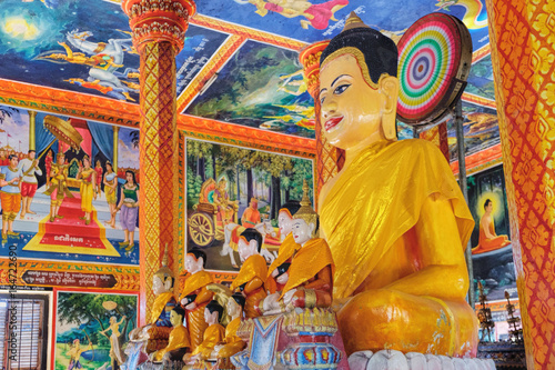 Buddha statue in the modern Theravada Buddhist monastery built near the historical Lolei temple photo