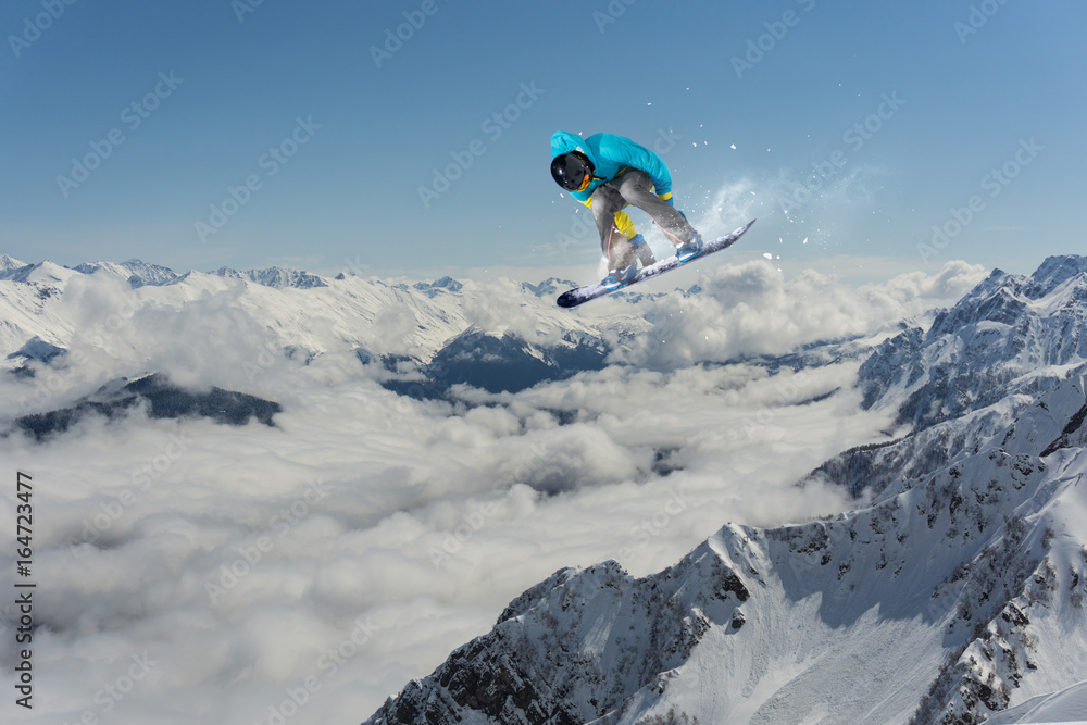 Flying snowboarder on mountains